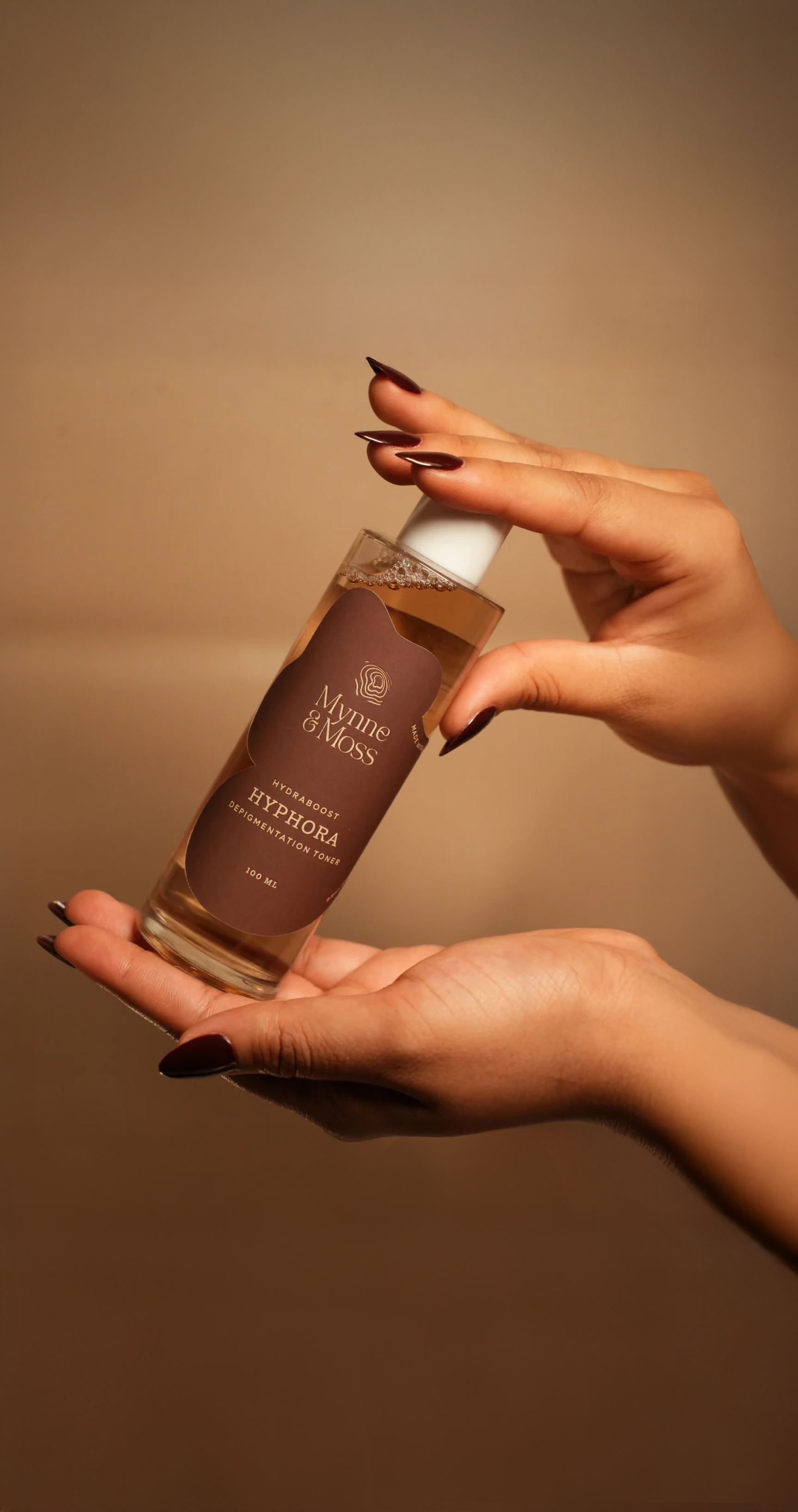 Hands holding the Hyphora depigmentation toner