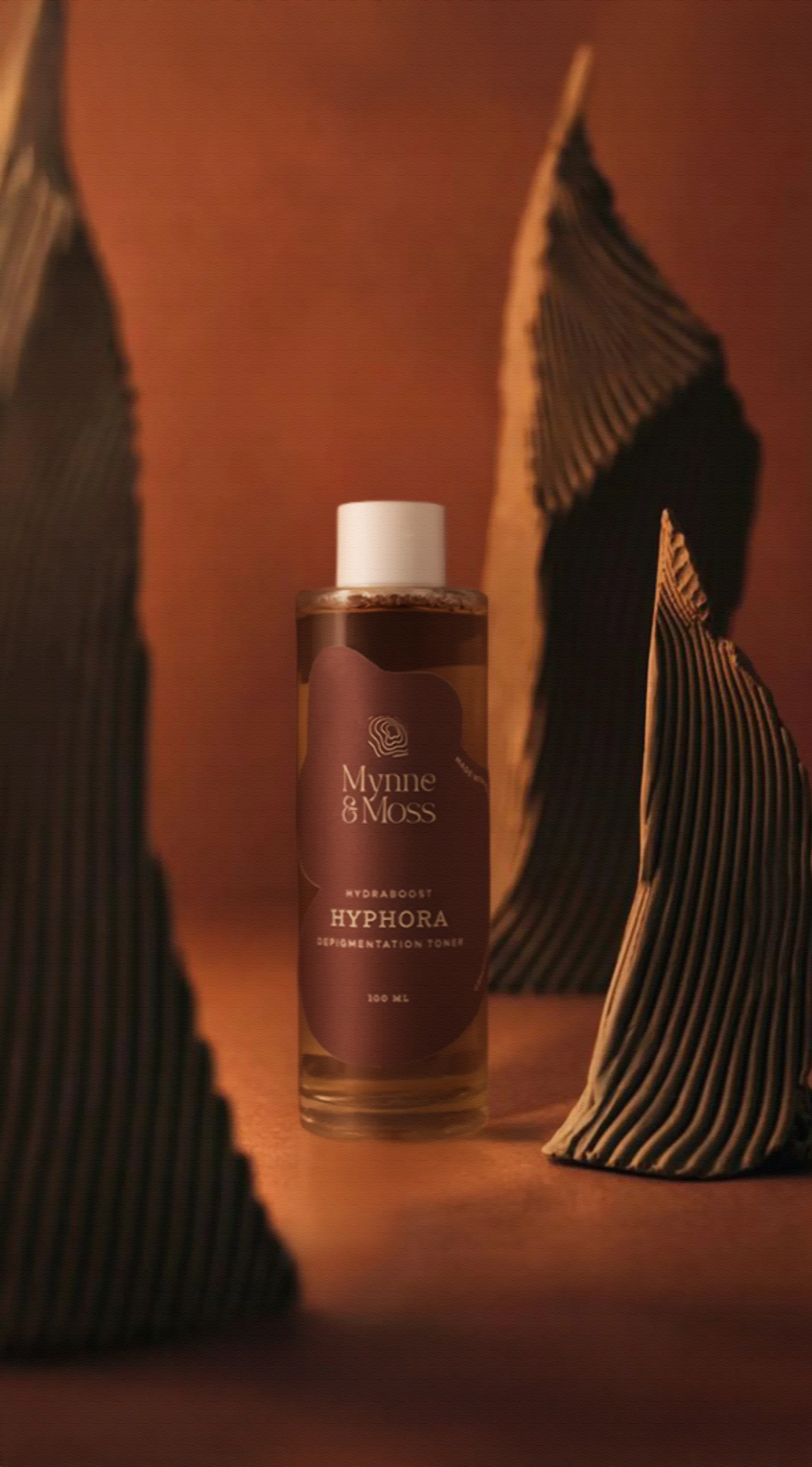 Hyphora depigmentation toner amid dried palm leaves
