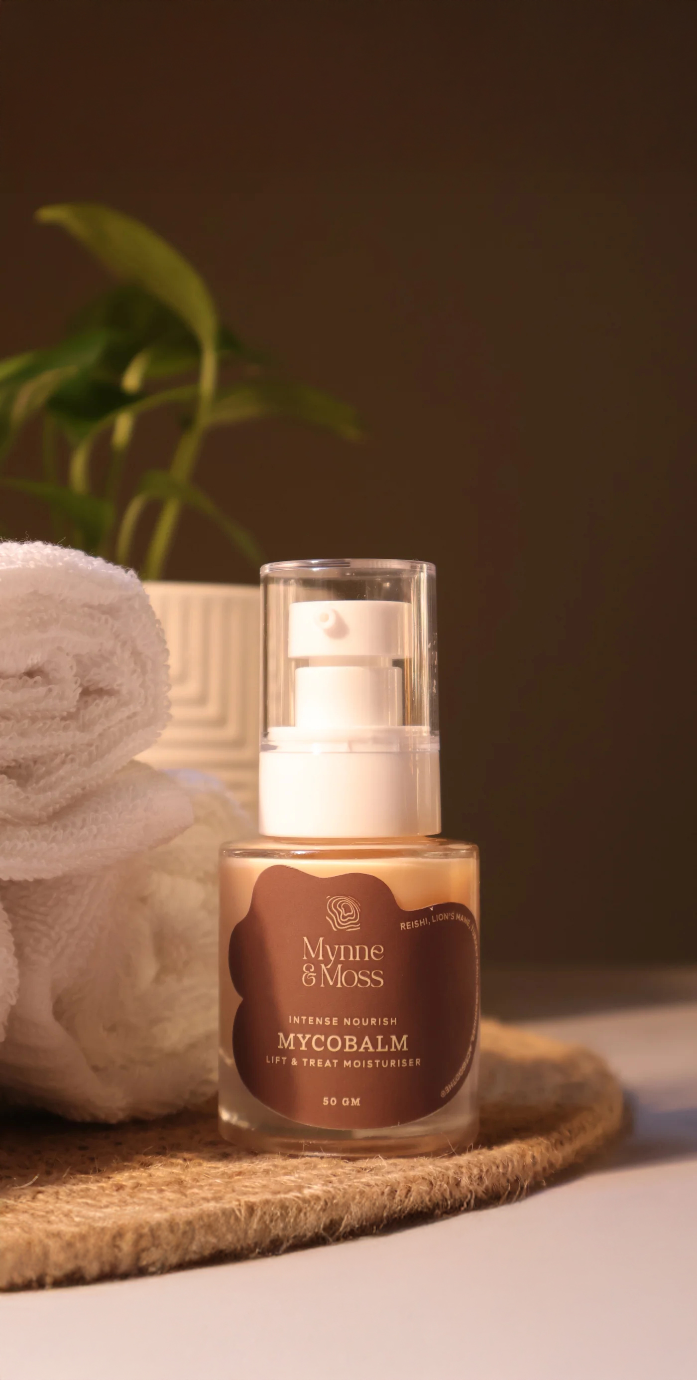 Mycobalm moisturiser beside a rolled towel and plant